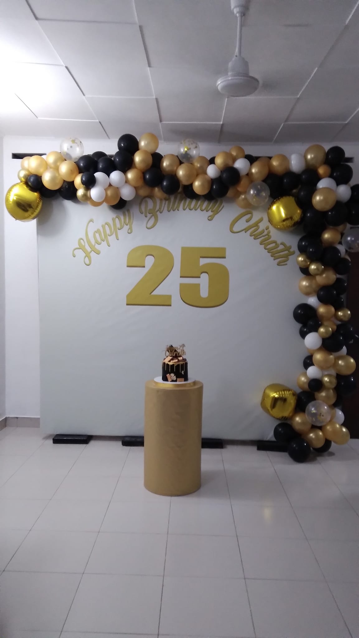 25th birthday balloon backdrop with number balloons and floral design